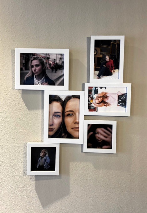 My slapdash gallery, with lovely stock photos inside. This entire thing is held up with nothing but magnets and a single 3M command picture hanging strip, but the outer frames were definitely pretty precarious. If I was installing it for real, I would screw them all in.